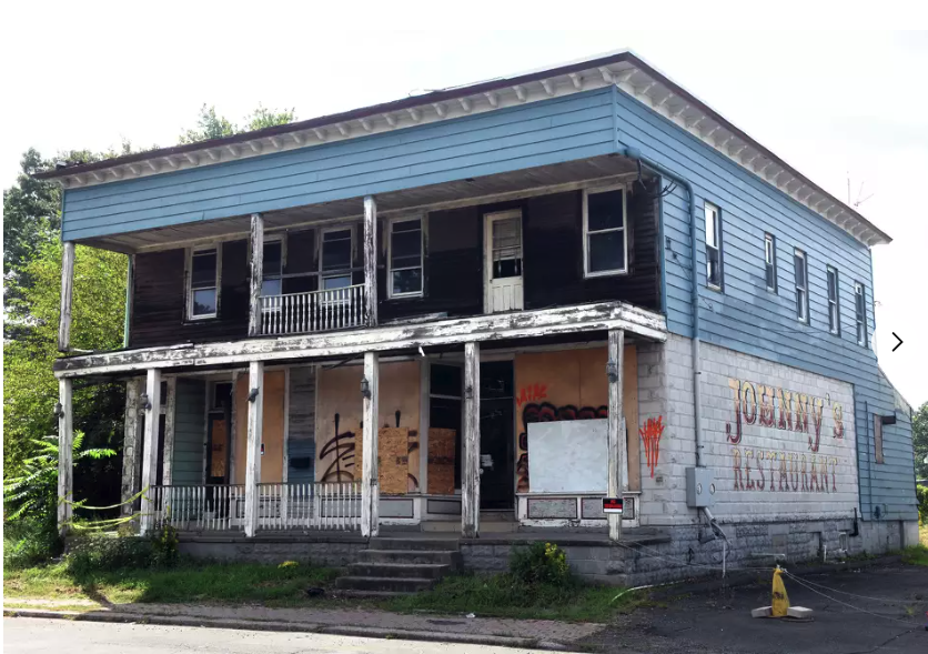 130 Honeyspot Road before renovation — vacant historic Johnny's Restaurant building